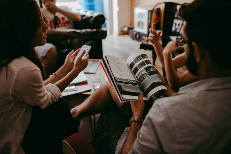 group of people reading a magazine
