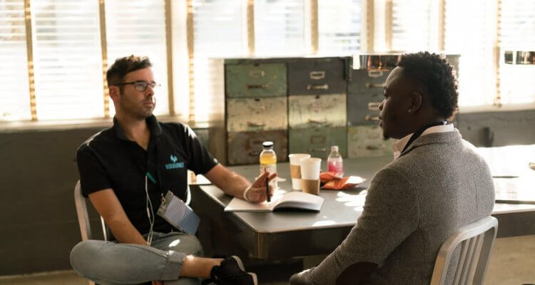 two men sitting at the table and talking