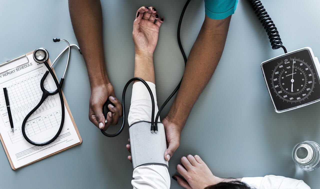 a nurse measuring a pressure with a stethoscope on the side